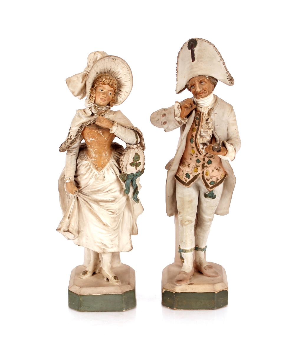 A pair of continental pottery figures of a man and a woman in period costume, the man taking a pinch