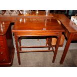 An Edwardian mahogany card table, with fold over rectangular top raised on square section supports