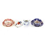 An early 19th Century blue and white cup and saucer, an early 19th Century  famille rose cup and