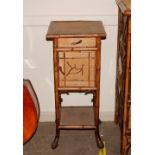 A late 19th Century bamboo bedside cabinet, the over hanging top above single drawer and zinc