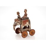 A 19th Century pull-a-long toy, in the form of an elephant and two riders, 41cm high