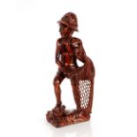 A carved hardwood figure of a fisherman, 45cm high