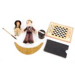 Two dolls; an ebony box decorated with whale to lid; a pocket chess set in card case; an antique