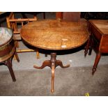 A 19th Century oak circular snap top occasional table, raised on turned column and tripod base, 77.