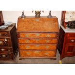 An 18th Century burr elm and walnut bureau, the fall front opening to reveal and interior