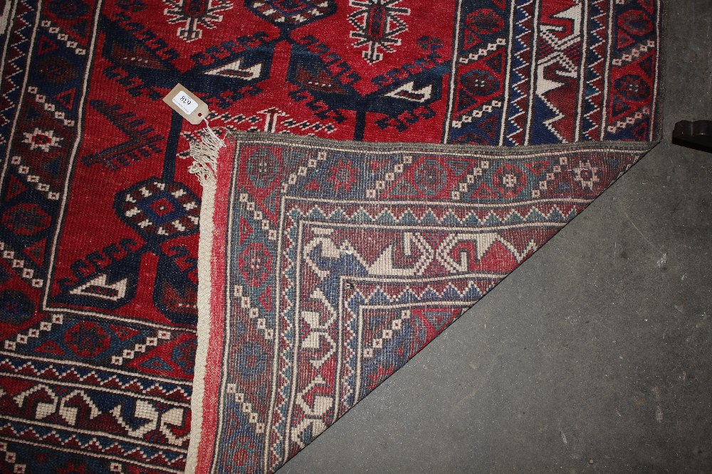 A Middle Eastern wool rug, of Caucasian design having stylised motifs on a brick red ground, 186cm x - Image 5 of 5