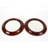 A pair of mahogany framed circular wall mirrors, 31cm dia. overall