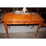 A Victorian walnut dressing table, fitted two drawers and raised on turned tapering supports,