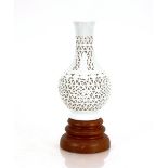 A Chinese blanc de chine vase, with pierced decoration on stand, 26.5cm high
