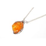 A fine amber / silver pendant and chain