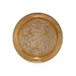An Eastern brass and white metal inlaid tray, 33cm dia.