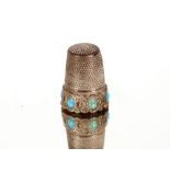 A silver thimble, inset with turquoise stones