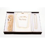 A pearl necklace with 9ct gold clasp; two pearl necklaces with white metal clasps; two pairs of