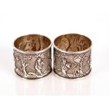 Two Chinese white metal serviette rings