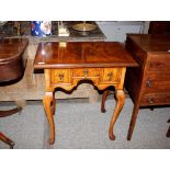 A walnut and herringbone banded low boy, in the Georgian style fitted three frieze drawers raised