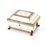 An Anglo / Indian ivory work box, with divisioned interior flanked by masked carrying handles and