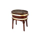 A George III mahogany oval wine cooler, brass banded and raised on a base with square section