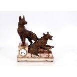 A French marble and bronze clock, surmounted by dogs on a stepped base, eight day movement to the