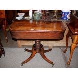 A Victorian mahogany card table, having baize lined fold over D shaped top, raised on ring turned