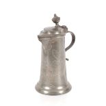 A pewter flagon with wriggle work decoration, inscribed "L.Amberge", the lid with finial thumb piece