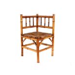 A 19th Century bamboo corner chair, having rush seat