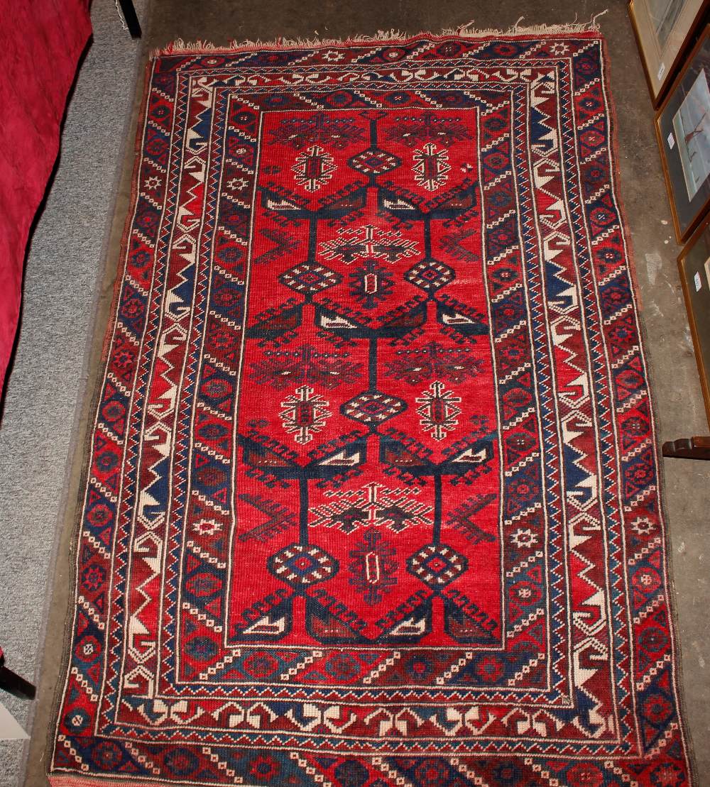 A Middle Eastern wool rug, of Caucasian design having stylised motifs on a brick red ground, 186cm x - Image 2 of 5