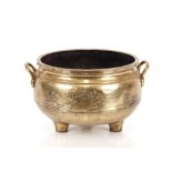 A 19th Century Chinese bronze censer, of large size, flanked by loop handles and having raised