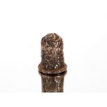 An ornate silver thimble