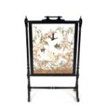 A late Victorian ebonised taxidermy worked firescreen, 96cm high x 64cm wide