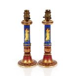 A pair of 19th Century porcelain candlesticks, decorated in the Greek classical manner, stamped to