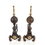 A pair of antique cast iron and brass mounted fire dogs, of baluster form