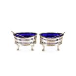 A pair of late Victorian silver oval salts, with blue glass liners, Birmingham 1886; and a pair of