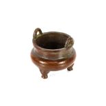 A small oriental bronze censer, with loop handles, 5.5cm dia. x 4.5cm high