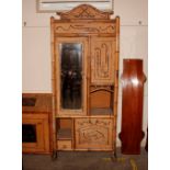 A 19th Century bamboo and rattan combination wardrobe, the hanging section enclosed by a mirrored