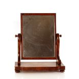 A Victorian mahogany swing framed toilet mirror, on shaped plateau base terminating in bun feet,