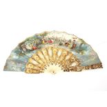 An ivorine and gilt decorated fan, the panels with printed scenes of dancing ladies in rural