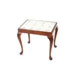 A walnut framed cabriole legged coffee table, the top inset with Delft tiles