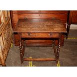 A 18th Century oak side table, the overhanging top above a single drawer with iron loop handles