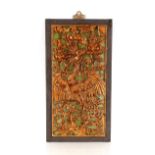 A Chinese carved and lacquered panel, depicting an exotic bird amongst foliage, 54cm x 30cm