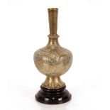 An Indian brass bottle shaped vase, an later hardwood stand, 28cm high