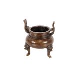 A Chinese bronze censer, of baluster form with elongated loop handles raised on three beast