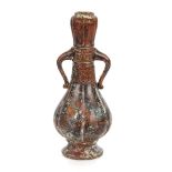 An archaic style metalware vase, with garlic neck and raised symbol decoration, 29cm high