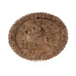 An oval 19th Century carved oak panel, depicting figure on horseback within a leaf border
