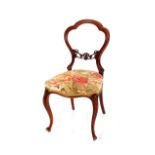 A pair of Victorian walnut balloon back dining chairs, with floral upholstered stuff over seats