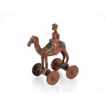 A 19th Century pull along toy, in the form of a camel and rider, 39cm high