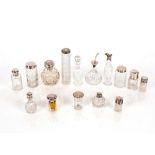 A collection of various cut glass and silver mounted scent bottles, hat pin jar, cruet bottle,