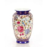 A large Oriental famille rose decorated baluster vase, 30cm high