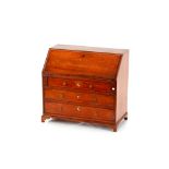 A miniature mahogany bureau, the fall front revealing a fitted interior above three graduated
