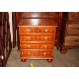 A yew wood oyster veneered chest, of small proportions, fitted two short and three long drawers,