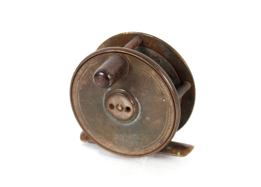 A brass Hardy fishing reel, 6.4cm dia. overall